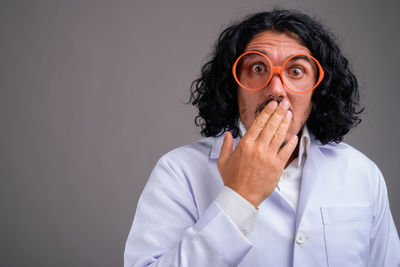 Portrait of man wearing mask against black background