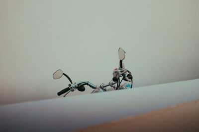 Cropped image of motorcycle against wall