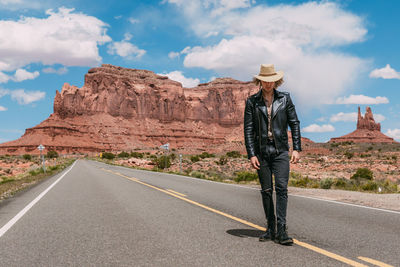 Man standing on road against sky