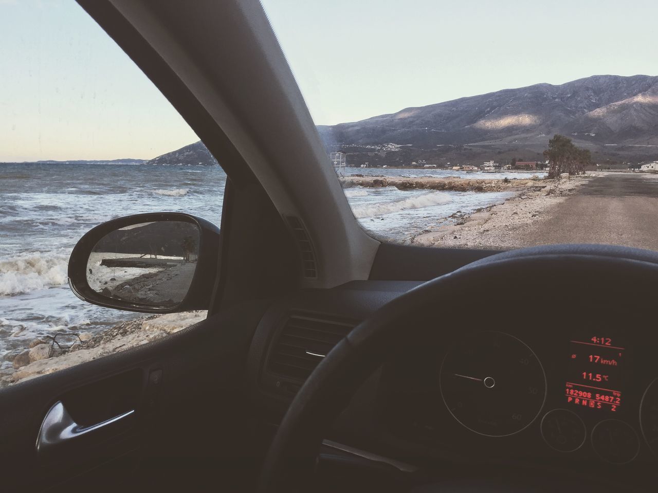 CLOSE-UP OF SEA SEEN THROUGH CAR WINDSHIELD