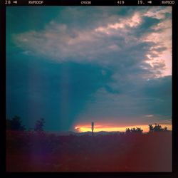 Scenic view of landscape against cloudy sky