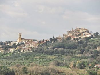 Buildings in town against sky