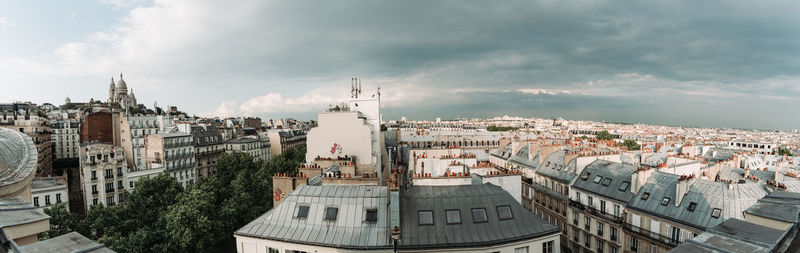 High angle view of buildings in town against sky