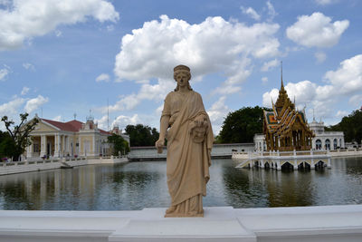 Statue of temple against cloudy sky