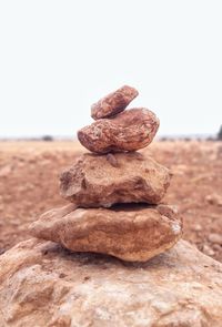 Stack of rock on table against clear sky