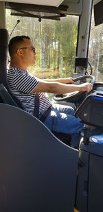 Low section of man sitting in bus