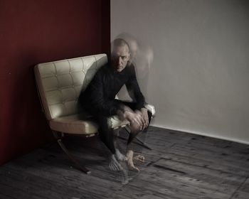 Young man sitting on floor at home