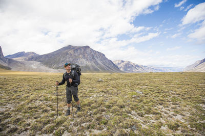 Man hiking in akshayak pass, canada.