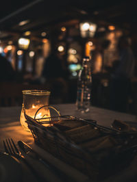 Illuminated tea light on table in restaurant