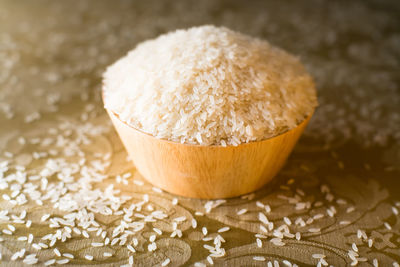 Close-up of rice in bowl and table