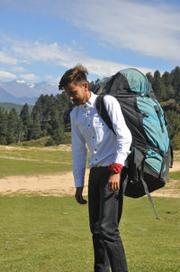 A male tourist with parachute backpack in the mountain 