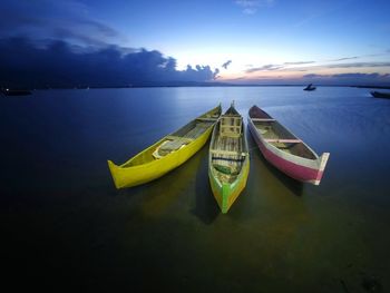 Boats moored in sea against sky