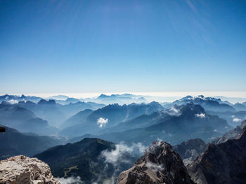 Scenic view of silhouette mountains against blue sky