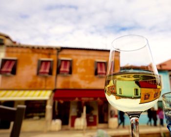 Close-up of wineglass against sky