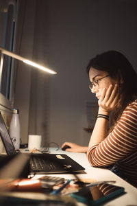 Young woman using mobile phone at office