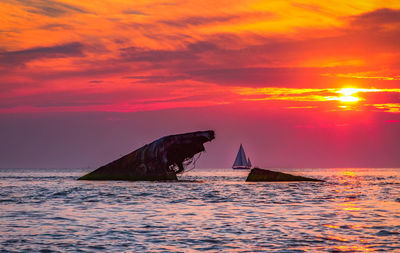 Scenic view of sea against orange sky