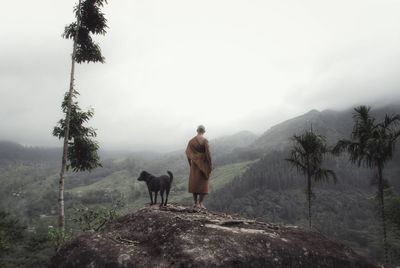 Man standing on mountains against sky