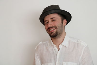 Portrait of smiling young man against white background