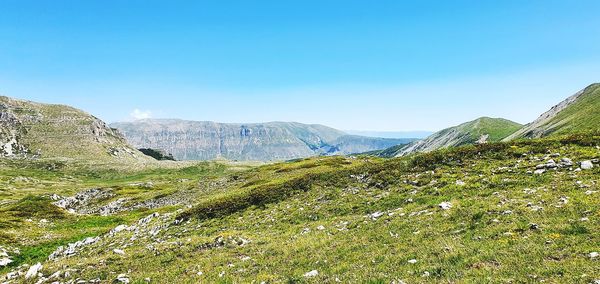 Scenic view of mountains against clear blue sky