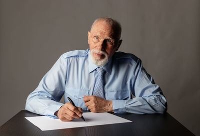 Portrait of man sitting on table
