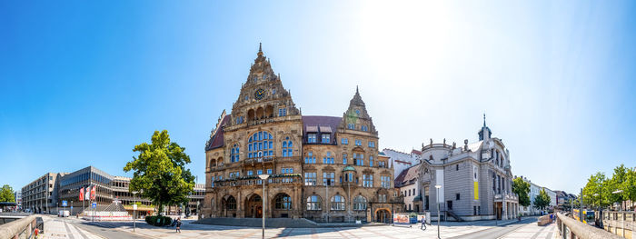 Panoramic view of historic building against blue sky