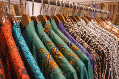 Full frame shot of clothes hanging on rack for sale in store