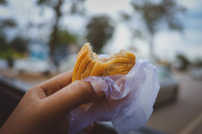 Close-up of hand holding curry puff pastry
