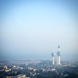 Buildings in city against clear sky