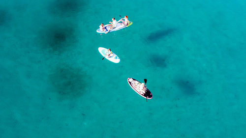 High angle view of people swimming in sea