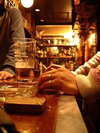 Cropped image of woman sitting in restaurant