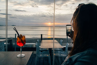 Rear view of woman using mobile phone