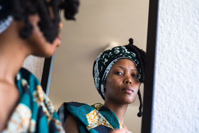 Woman reflecting on mirror at home