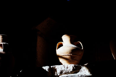 Close-up of statue against black background