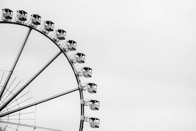 Low angle view of ferris wheel at park against clear sky