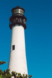 Low angle view of lighthouse against clear blue sky