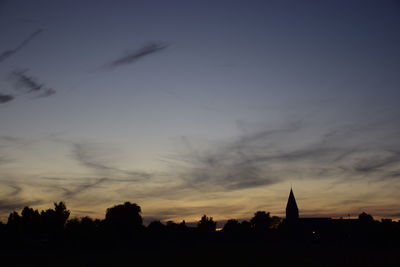 Silhouette of trees against sky at sunset