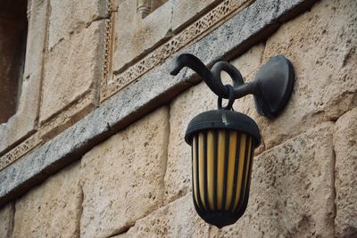 Low angle view of lamp mounted on wall