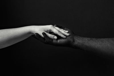 Close-up of hand over black background