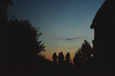 Silhouette people against sky during sunset