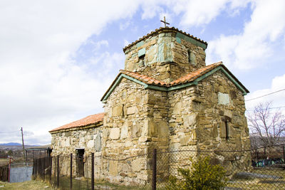 Old stone church exterior and blue sky view in kavtiskhevi, georgia