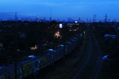 High angle view of railroad tracks against sky at night