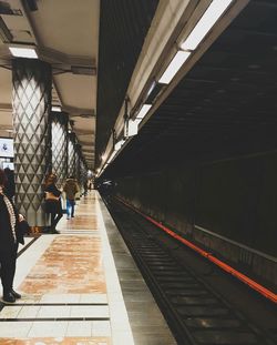 People waiting at railroad station platform