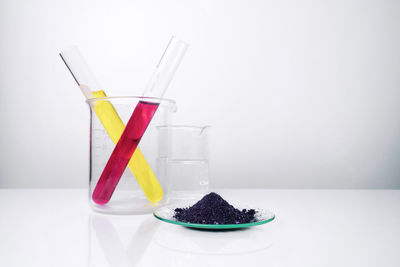 Close-up of cake on glass table against white background