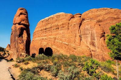 Low angle view of rocky mountain against sky