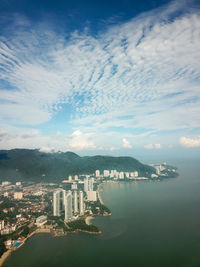 High angle view of city by sea against sky