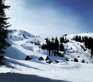 Scenic view of snow covered mountains against sky