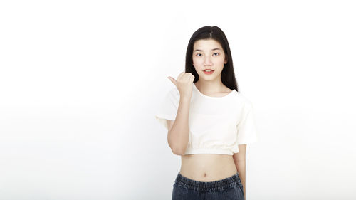 Portrait of woman standing against white background