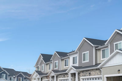 Low angle view of buildings against blue sky