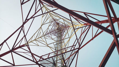 Low angle view of electricity pylon against sky
