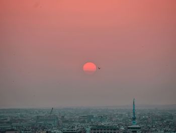 Aerial view of cityscape against sky during sunset